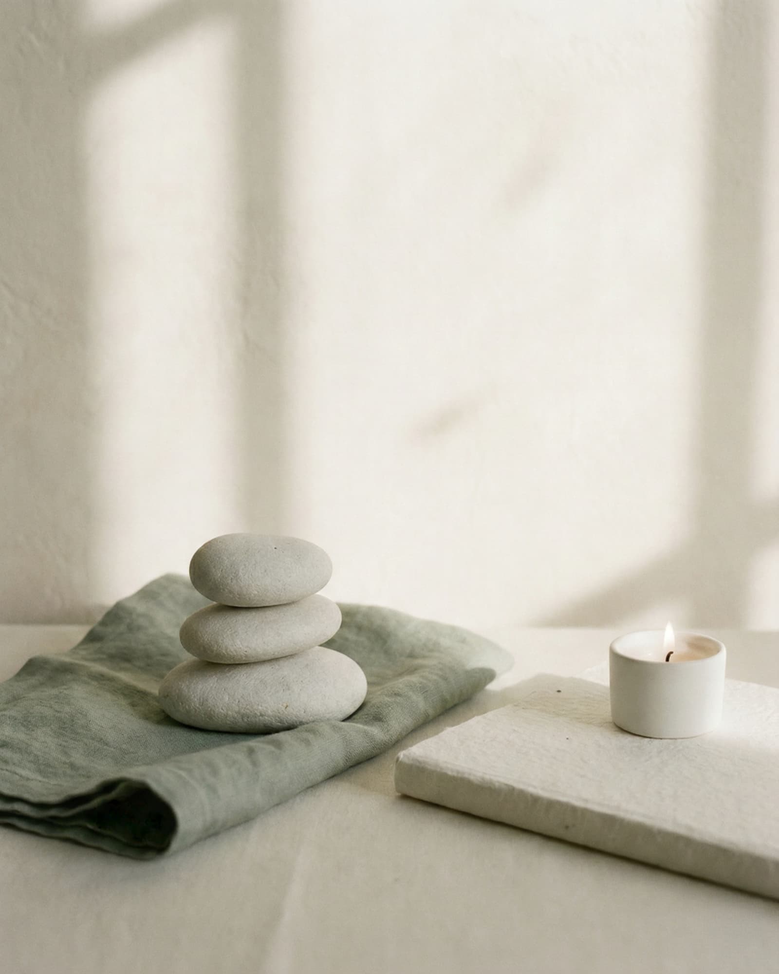 Minimalist still life symbolizing emotional balance with smooth stones and journal